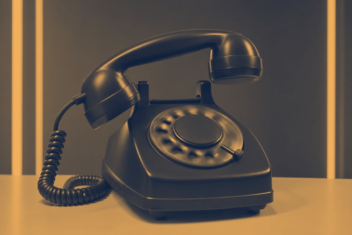 A desk phone caught mid-ring